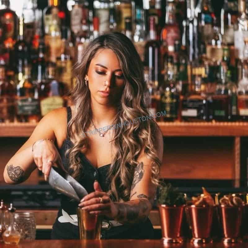 Topless bartender pouring and serving guests through a full event